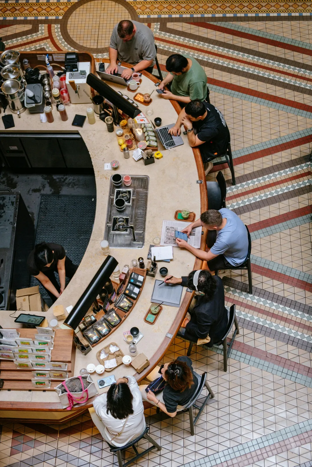 People working and gathering at a café counter in Sydney